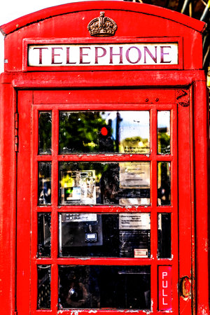 Traditional Red Pay Telephone Booth Westminster London England.  A symbol of England and the UK.