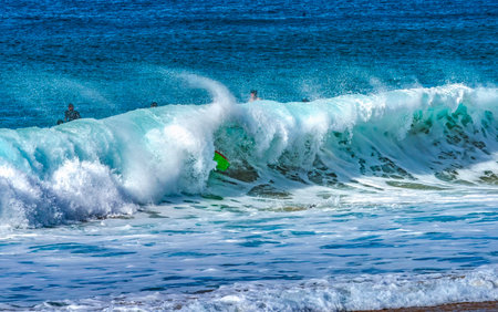 Colorful Surfboard After Wipe Out Large Wave Banzai Pipeline North Shore Oahu Hawaii. Huge Waves Over Shallow Reef create tube over a shallow reef creates a beautiful place to surf.の写真素材