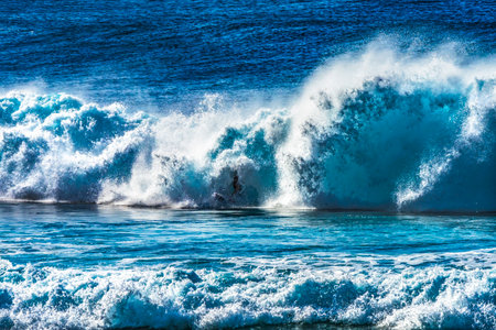 Colorful Surfer Green Room Large Wave Banzai Pipeline Pipeline North Shore Oahu Hawaii. Huge Waves Over Shallow Reef create tubes, large hollow curls of water that surfers can ride. The shallow reef creates a beautiful place to surf.の写真素材