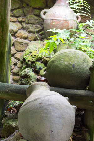 Antique water jar or jug being displayed in parkの写真素材