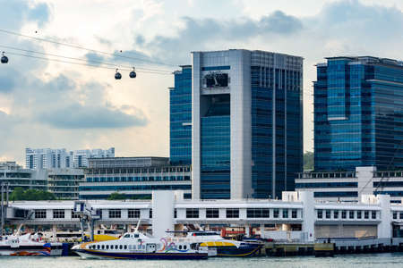 Harbour Front buldings and bay with cable cars and large ships, Singapore, March 30, 2020のeditorial素材