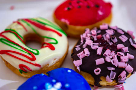 Colorful blue, red, brown and stripe donuts with white background
