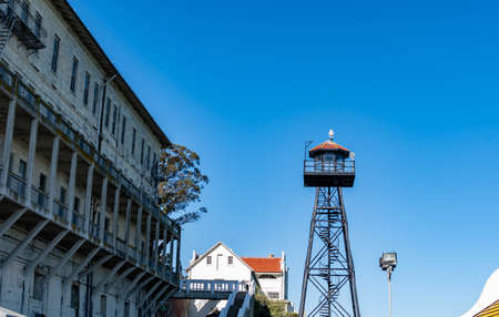 Alcatraz island's boat ship dock with the barracks or appartments and guard tower from the front or center part of the islandのeditorial素材