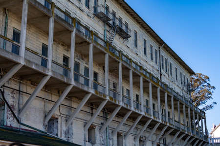 Alcatraz island's boat ship dock with the barracks or appartments and guard tower from the front or center part of the islandのeditorial素材