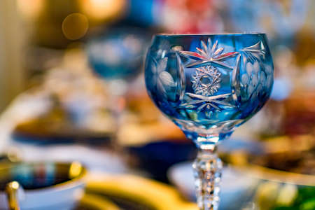 Closeup shot of a wine glass with blurry dinner backgroundの写真素材
