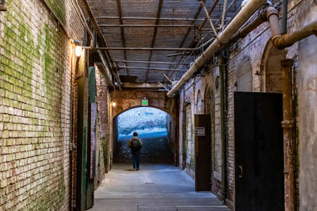 Alcatraz Prison old hallway inside the barracks apartment with rusty walls, ceiling grills and pipesのeditorial素材