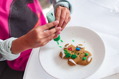 Gingerbread Cookie Man while being decorated by a kid