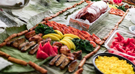 Boodle fight style of eating. A traditional filipino way of eating together with family and friendsの写真素材