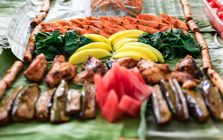 Boodle fight style of eating. A traditional filipino way of eating together with family and friendsの写真素材