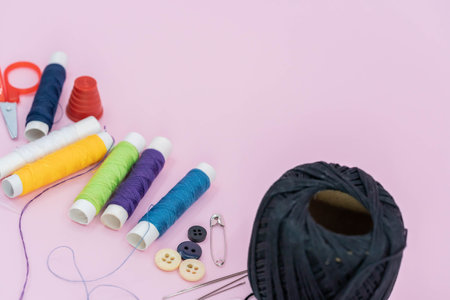 Sewing background. Accessories for needlework on wooden background. Spools of thread, scissors,...
