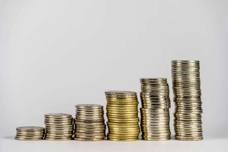 Place the coins in a line from low to high. Manage your savings to grow by investing in stocks or funds. Idea of growing money.の写真素材