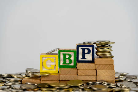 Forex GBP concept with wooden blocks and coins. Forx GBP letters on wooden blocks sorrounded with moneyの写真素材