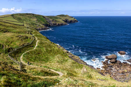 Rocky coast with footpath and blue skyの写真素材