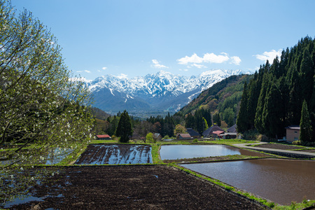 Beautiful view of Spring Snowy Mountain and mountain village.の写真素材