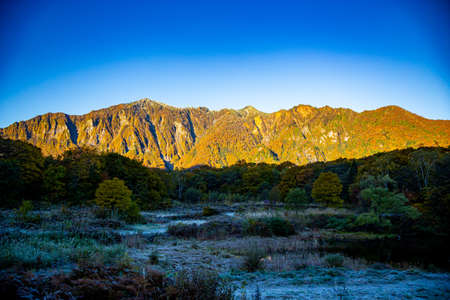 Beautiful view of the autumn leaves of Mt. Torikabuto seen from Amaike.の写真素材