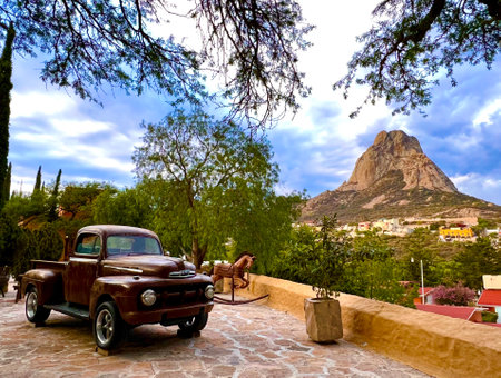 Old retro car in the village. Rock Mountain in the background.の写真素材