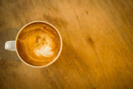 Hot Late, a cup of coffee on wooden table