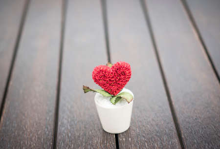 Love tree pot on wooden floor with copy space for quote,phrase or saying