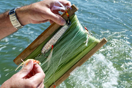 a fisherman preparing fishing hook in the sea