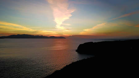 Natural dramatic sunset sunrise with white cloud and blue sky as background of black coralの写真素材