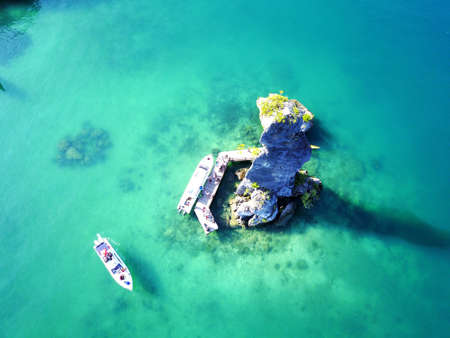 Aerial view of seascape with turquoise clear water and luxury boats taken by droneの写真素材