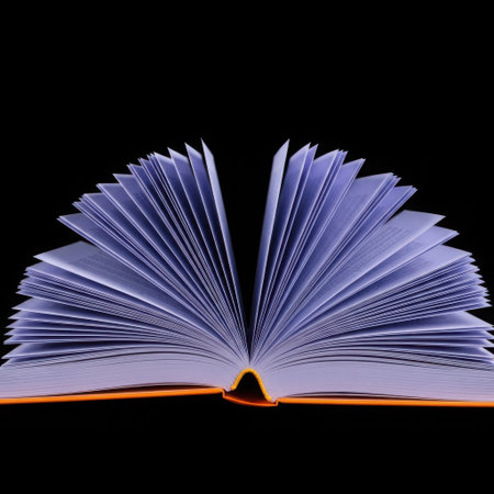 An open book with its pages fanned out, illuminated with a soft purple light against a stark black background.の素材