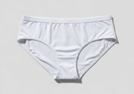 A pair of plain white high-waisted cotton briefs for women, presented flat against a neutral background.の素材