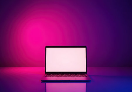 A sleek, modern laptop displays a blank white screen, illuminated by vibrant pink and blue neon lights, isolated on a white background.の素材