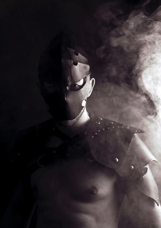 Warrior in mask in abstract smoke on black backgroundの写真素材