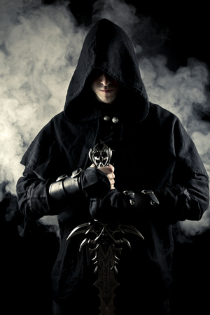Warrior with sword and smoke on black background.の写真素材