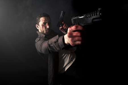 Portrait of attractive and young, smoking gangster.