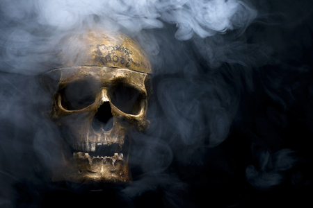 Close up of skull on black background around the smoke.の写真素材