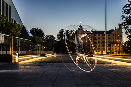 Cyr wheel performance session by young man at night.の写真素材