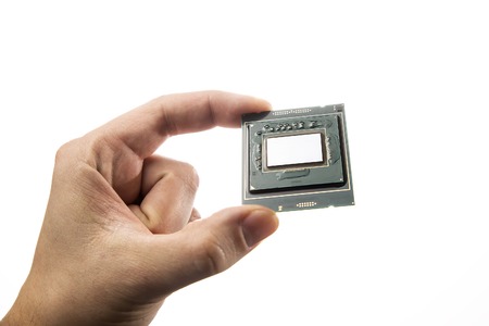 Clean CPUs PCB. No thermal paste in mans hand isolated on white background.の写真素材