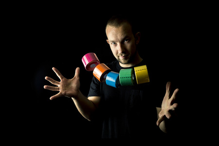 Portrait of young and attractive man, physiotherapist with a lot of medical tapes.
