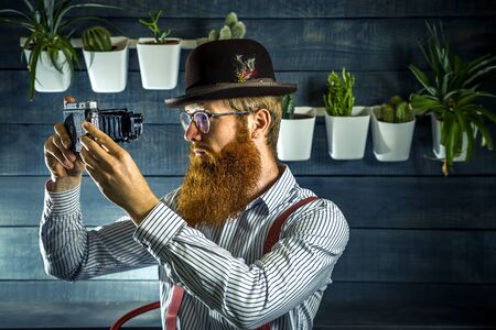 Portrait of bearded hipster with ginger hair in barbershop.の写真素材