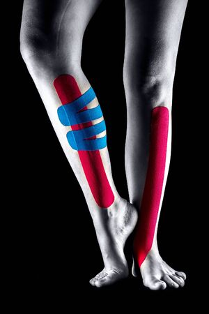 Medical taping for leg pain relief showed on young model.の写真素材