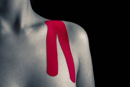 Therapy with madical tape. Pink tape on woman.の写真素材