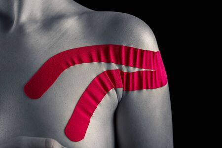 Therapy with madical tape. Pink tape on woman.の写真素材