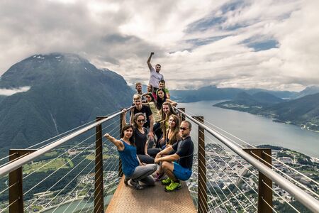 Young people on the top of mountain, Alesund, Norwayの写真素材