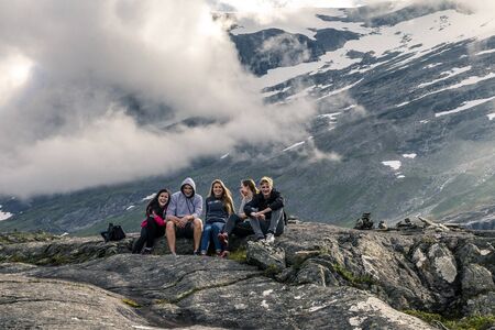 Young people are having fun on the top of mountain, Trollstigen, Norwayの写真素材