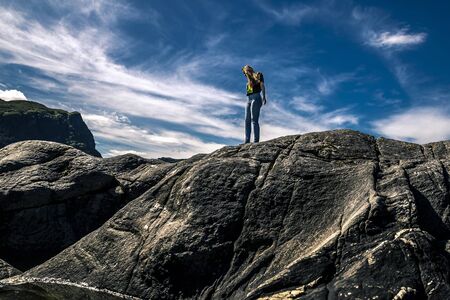Young woman standing on the rocks, Norway