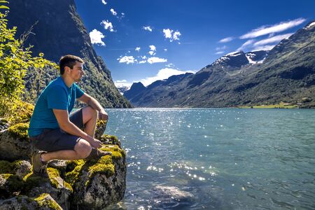 Young man is having fun hiking in Norway