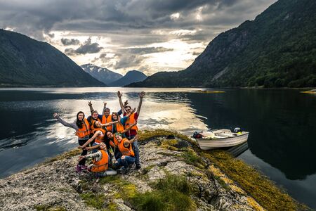 Young friends having fun on the picnic on the island of Norwayの写真素材