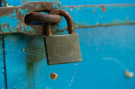 old padlock on the fence in the yardの写真素材