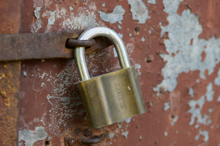 old padlock on the fence in the yard