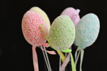 Easter eggs on black background, closeup of photo with shallow depth of field