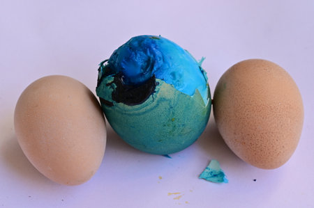 Easter eggs painted in blue and green on a white background.の写真素材