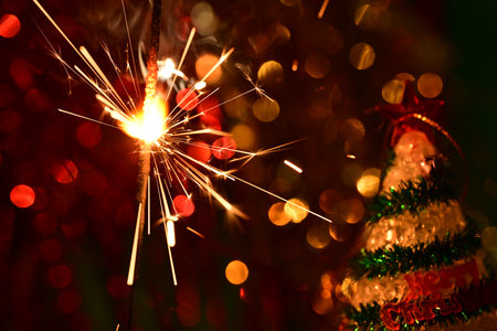 Christmas tree and sparkler on bokeh background. New Year conceptの写真素材
