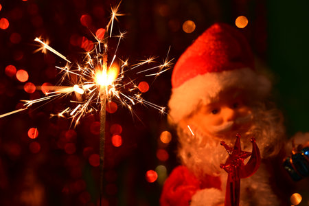 Christmas background with Santa Claus and sparkler on bokeh backgroundの写真素材